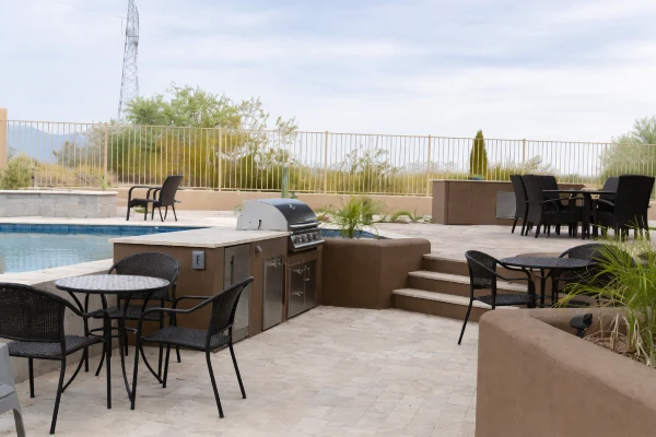 Custom outdoor kitchen with grill and bar seating